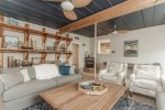 Off the kitchen is a cozy den with cabin vibes
